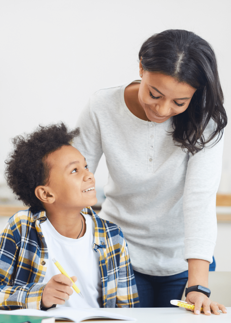 mom helping boy with homework